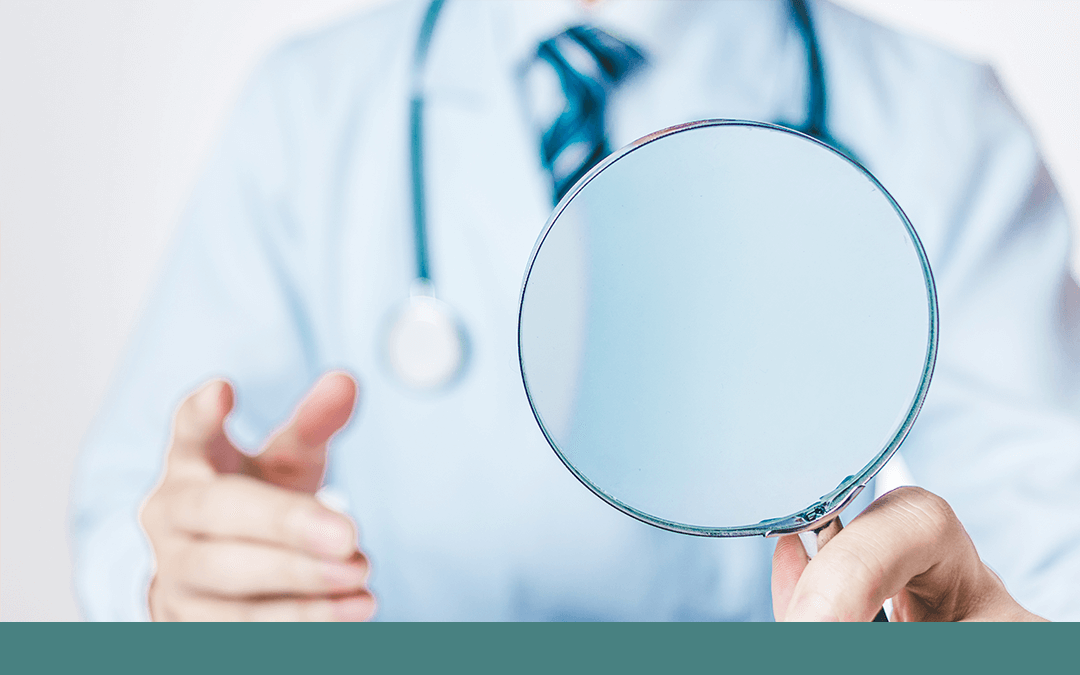 Photo of doctor holding a magnifying glass